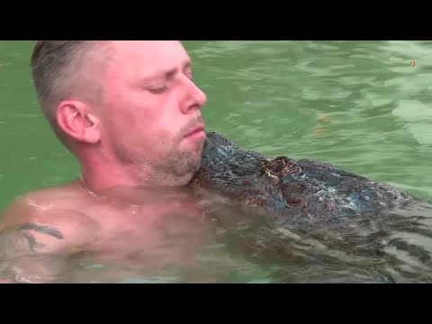 German who cuddles with his pet alligator