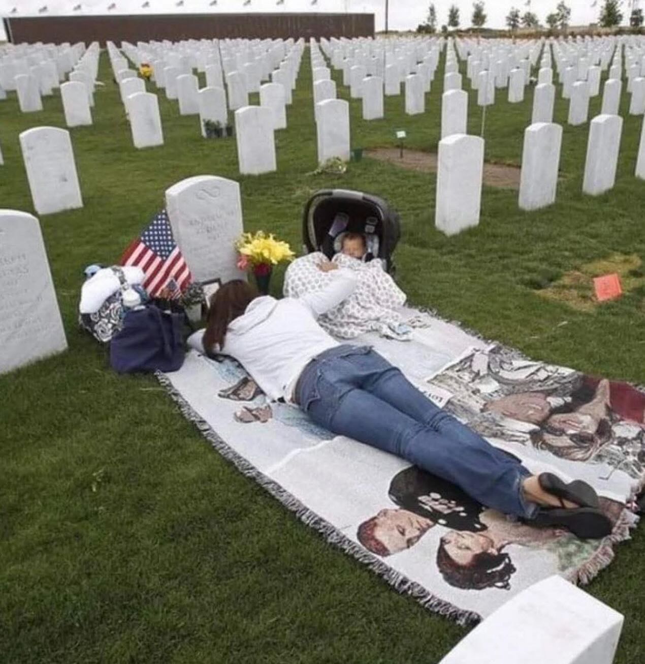Woman lies on the grave of her late soldier husband on Memorial day